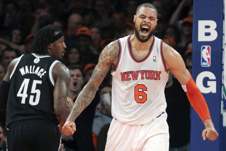   Brooklyn Nets' Gerald Wallace (45) watches as New York Knicks' Tyson Chandler (6) reacts after dunking during the second half of an NBA basketball game, Wednesday, Dec. 19, 2012, at Madison Square Garden in New York. The Knicks won 100-86. (AP Photo/Mary Altaffer)  