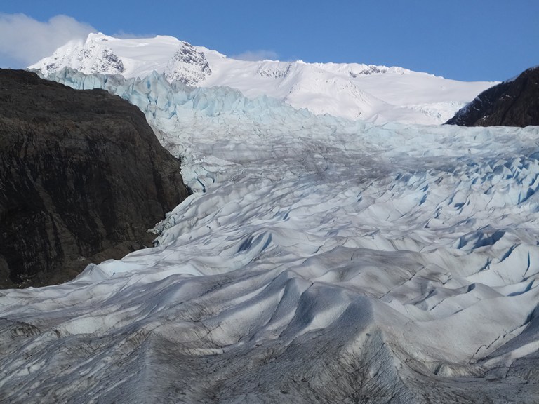File - In this Feb. 15, 2016 file photo, snow-covered mountains are seen behind the Mendenhall Glacier in Juneau, Alaska. The massive Alaska ice field that feeds Juneau's Mendenhall Glacier, a tourist attraction viewed by hundreds of thousands each year, could be gone by 2200 if climate warming trends continue, according to a new University of Alaska Fairbanks study. (AP Photo/Becky Bohrer, File)