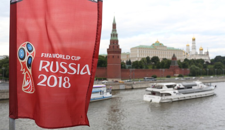 A Russia World Cup banner flies beside the River Moskva, opposition the Kremlin complex in Moscow, Russia, on Saturday, June 9, 2018. FIFA expects more than three billion viewers for the World Cup that begins this week in Russia.