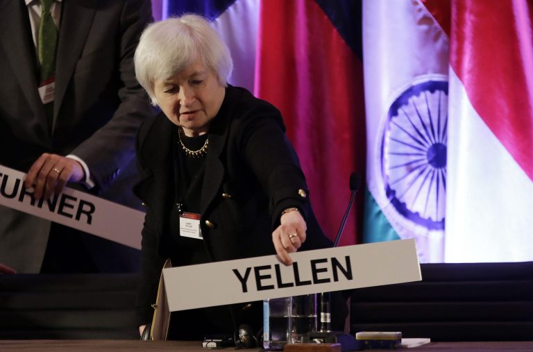FILE - In this  Monday, June 3, 2013, file photo, Janet Yellen, vice chair of the Board of Governors of the Federal Reserve System, places her name plate at her seat at the International Monetary Conference in Shanghai, China. As of Sunday, Sept. 15, 2013, Yellen is the clear front-runner to be nominated as chair of the federal Reserve. (AP Photo/Eugene Hoshiko, File)