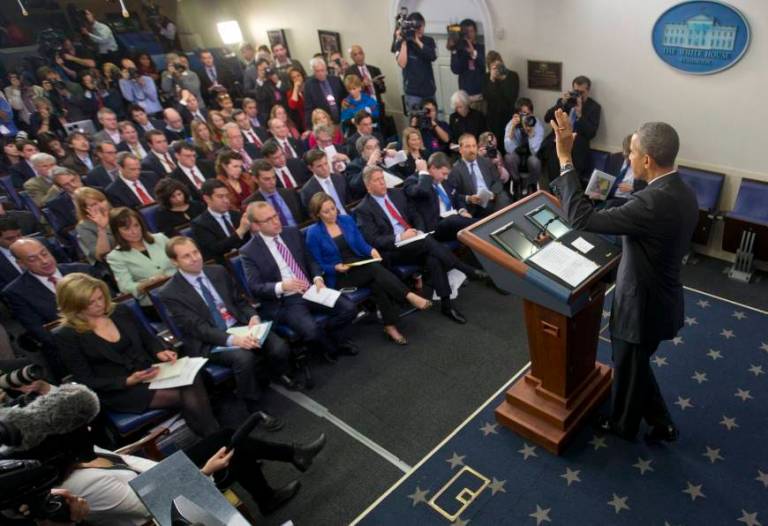 President Obama waves to reporters in the White House briefing room. AP Photo