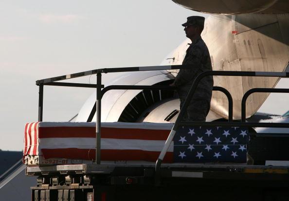 A U.S. Marine stands near a flag-draped transfer case holding the remains of U.S. Marine Lance Corporal Blaise A. Oleski, of Holland Patent, New York at Dover Air Force Base, in this April 9, 2009 file photo in Dover, Delaware. (Photo by Mark Wilson/Getty Images) 