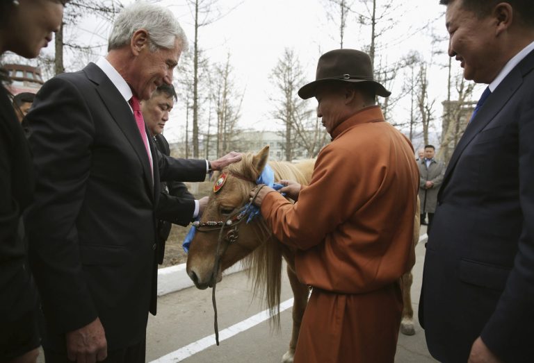 U.S. Secretary of Defense Chuck Hagel, left, is presented with a horse as a gift by Mongolian Defense Minister Bat-Erdene Dashdemberel, right, at the Mongolian Ministry of Defense, Thursday, April 10, 2014, in Ulan Bator, Mongolia.  (AP Photo/Alex Wong, Pool)
