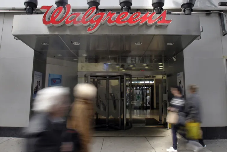   In this Wednesday, Oct. 17, 2012 photo, people pass the Walgreens store in New York's Times Square. Walgreen Co.'s fiscal first-quarter earnings sank nearly 26 percent as the nation's largest drugstore chain filled fewer prescriptions and absorbed costs tied to acquisitions and Superstorm Sandy. The Deerfield, Ill., company's performance fell short of Wall Street expectations, and the stock slipped Friday, Dec. 21, 2012, before markets opened. (AP Photo/Richard Drew)  