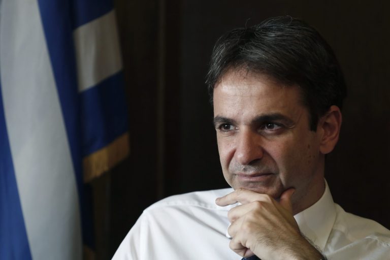 Greek Administrative Reform Minister Kyriakos Mitsotakis listens during an interview with the Associated Press in Athens, Tuesday, April 8, 2014. Mitsotakis said years of austerity have left Greece with about 200,000 fewer civil servants than before its debt crisis erupted in late 2009. He added that  the country has made significant overall progress, which should allow it to tap international capital markets 