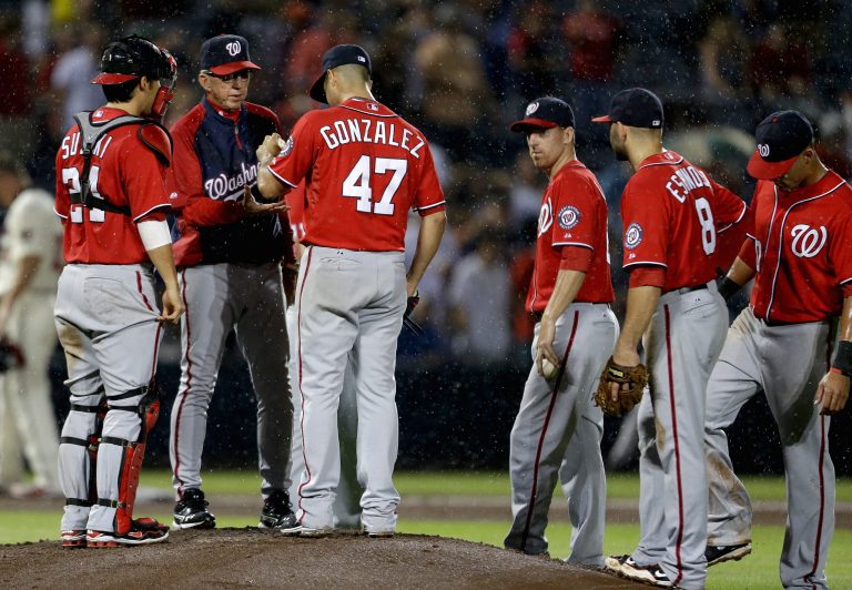 Washington Nationals manager Davey Johnson, second from left, relieves starting pitcher Gio Gonzalez in the sixth inning of a baseball game against the Atlanta Braves on Sunday. (AP Photo)