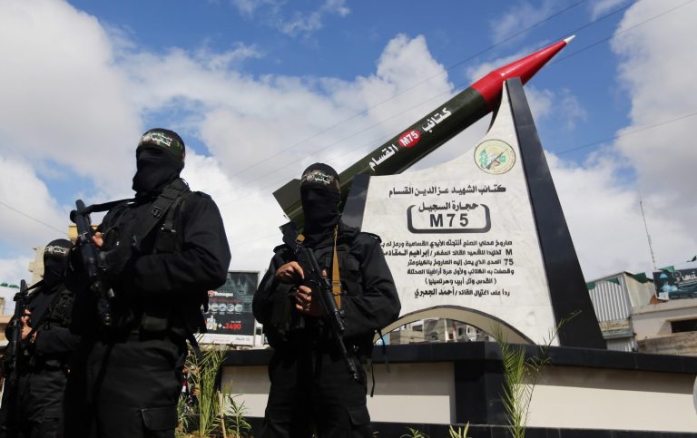 Hamas military wing members take part in a ceremony to inaugurate a monument marking the anniversary of the death of  a senior Hamas official Ibrahim Maqadama, killed in an Israeli air strike in 2003, in Gaza City , Monday, March 10, 2014. The monument represents a model of the Hamas made longer-range M75 missile which has  a range of about 80 kilometers and was used for the first time in 2012 against targets in Israel. (AP Photo/Hatem Moussa)