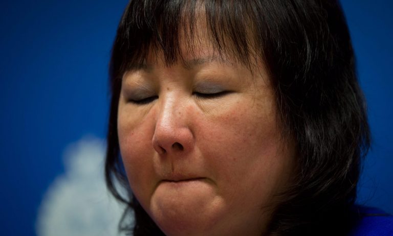 Carol Todd fights back tears as she listens during a Royal Canadian Mounted Police news conference in Surrey, British Columbia, on Thursday, April 17, 2014. A 35-year-old man alleged to be involved with the online extortion of Todd's 15-year-old daughter, who committed suicide in 2012, has been arrested in the Netherlands. (AP Photo/The Canadian Press, Darryl Dyck)