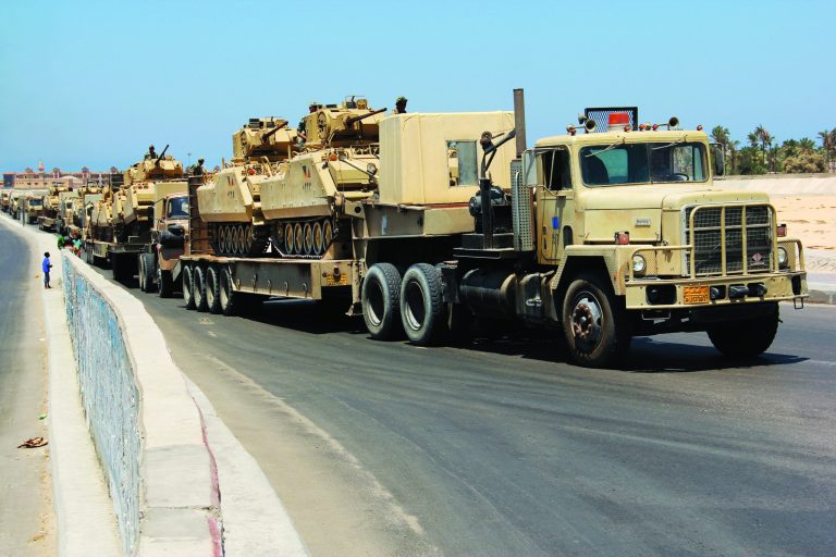 Army trucks carry Egyptian military tanks in El Arish, Egypt's northern Sinai Peninsula, Thursday, Aug. 9, 2012. Gunmen sprayed a police station in Egypt's Sinai with bullets Thursday, setting off a brief firefight with policemen before speeding away in their truck, the latest in a series of attacks against security forces in the increasingly volatile peninsula, security officials said. Meanwhile, the military sent additional armored and other army vehicles to boost its strength in a hunt for militants in the wake of a deadly weekend attack that killed 16 Egyptian soldiers. (AP Photo)