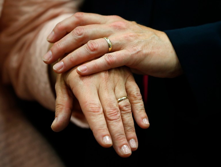Beth Asaro, left, and Joanne Schailey show off their wedding rings after exchanging vows and becoming the first same-sex couple marriage in the history of Lambertville, N.J., on Oct. 21. (AP Photo/Rich Schultz)