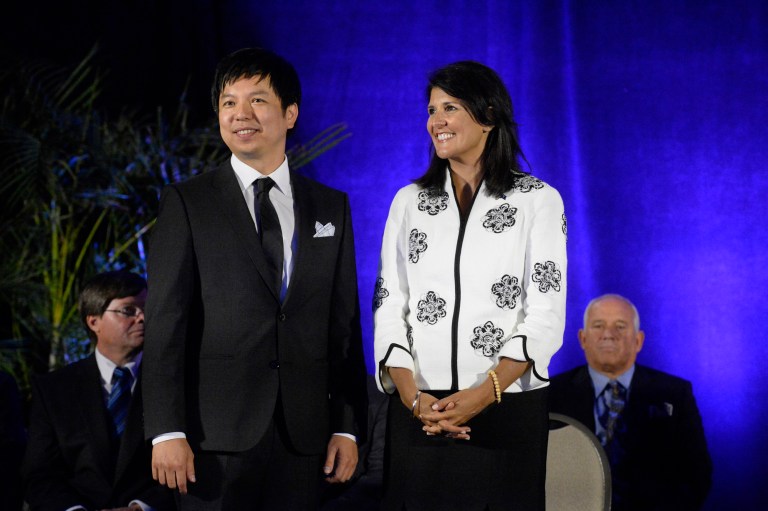 Dr. Enki Tan of Giti Tires, left, and South Carolina Gov. Nikki Haley announce Monday, June 16, 2014 that Gidi Tires' is building its first North American manufacturing facility in Chester County S.C. The Singapore-based tire manufacturer plans to spend $560 million in a Chester County plant expected to create 1,700 new jobs over the next decade. (AP Photo/The Charlotte Observer, Jeff Willhelm ) MAGS OUT; TV OUT; NEWSPAPER INTERNET ONLY