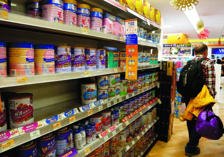 A man walks past shelves of baby formula at a shop in Hong Kong Friday, Feb. 1, 2013. Hong Kong announced measures Friday to curb the amount of baby formula that mainland Chinese visitors are buying as anger grows at shortages in the city's stores. Chief among the measures is a plan to change the law to restrict the amount of baby formula that individuals can take out of the city. Food and Health Secretary Ko Wing-man said legislation would be amended to prohibit taking more than 1.8 kilograms (4 pounds) of formula past Hong Kong's borders. The amount is equal to two cans of formula. (AP Photo/Vincent Yu)