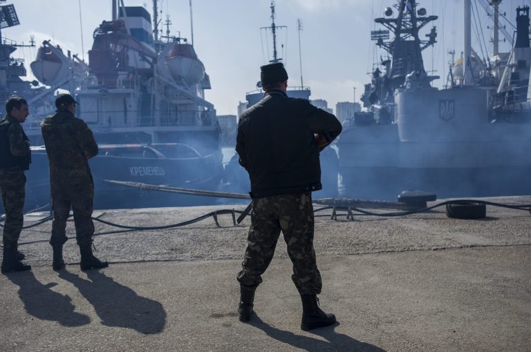 Men in unmarked uniforms stand guard during the seizure of the Ukrainian corvette Khmelnitsky in Sevastopol, Crimea, on Thursday. (AP Photo/Andrew Lubimov)
