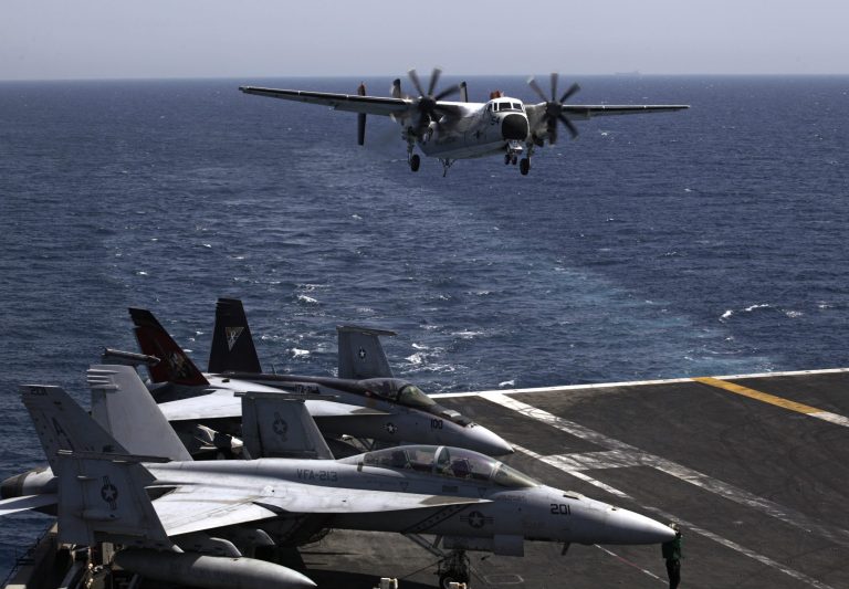 A U.S. military plane lands on the U.S. Navy aircraft carrier USS George H.W. Bush, in the Persian Gulf. As the United States looks to stitch together a coalition to tackle the extremist Islamic State group, the Obama administration will have to overcome the reluctance of Mideast allies who are deeply frustrated with a White House that they believe has been naive, fickle and weak on Syria's civil war. (AP Photo/Hasan Jamali)