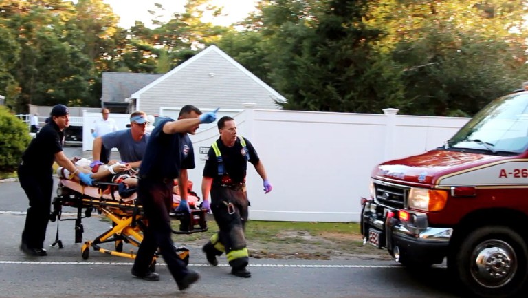 In this image taken from video provided by HyannisNews.com, a person is brought to an ambulance following a skydiving accident Sunday, Sept. 28, 2014, in Barnstable, Mass. Barnstable police say the skydiving instructor and student died shortly after the crash near the Cape Cod Airfield. (AP Photo/HyannisNews.com, Robert Bastille) MANDATORY CREDIT; BOSTON OUT; PROVIDENCE OUT
