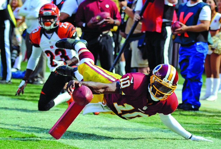 Nick Wass/AP
Robert Griffin III threw for 221 yards and a touchdown and ran for 85 yards and another score in the Redskins' loss to the Bengals on Sunday.