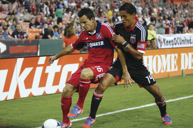 WASHINGTON, DC - AUGUST 4:  Marco Pappa #16 of the Chicago Fire shields the ball from Andy Najar #14 of D.C. United at RFK Stadium on August 22, 2012 in Washington, DC.(Photo by Ned Dishman/Getty Images)
