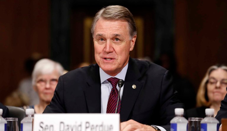 Republican senators, including Sen. David Perdue of Georgia (pictured), met Thursday to talk in a closed door meeting about the proposed tax plan, which faced immediate criticism for its proposal to slow down the corporate rate cut even before details were formally made public.(AP Photo/Alex Brandon)