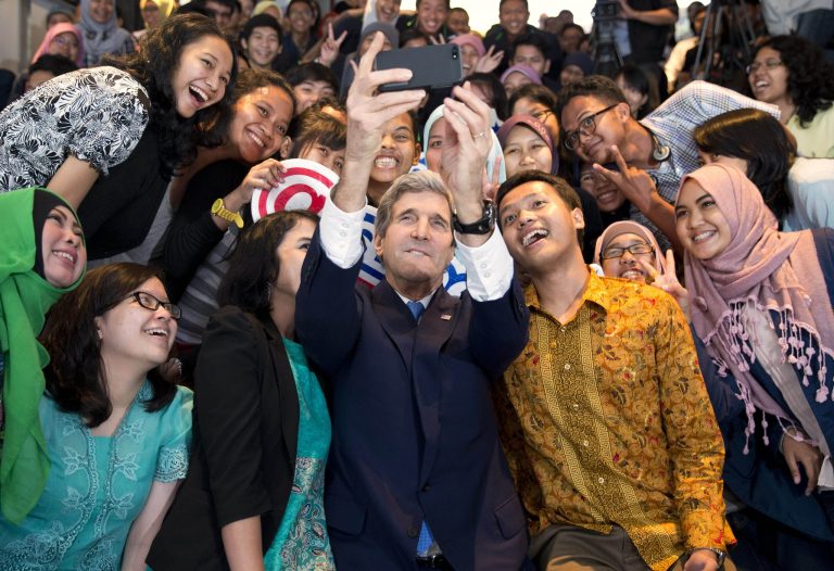 Secretary of State John Kerry takes a selfie with a group of students before delivering a speech on climate change on Sunday, Feb. 16, 2014, in Jakarta. Kerry called for a 