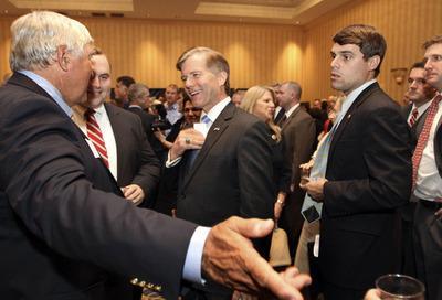 Virginia Gov. Bob McDonnell, center, talks with guests at a state GOP fundraiser on Monday in Concord, N.H.-Jim Cole/AP