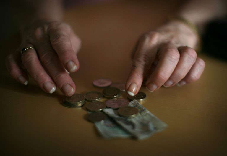 In this photo illustration an old age pensioner checks what is left of her weekly state pension on November 6, 2008, in Conwy, Wales. (Photo by Christopher Furlong/Getty Images)
