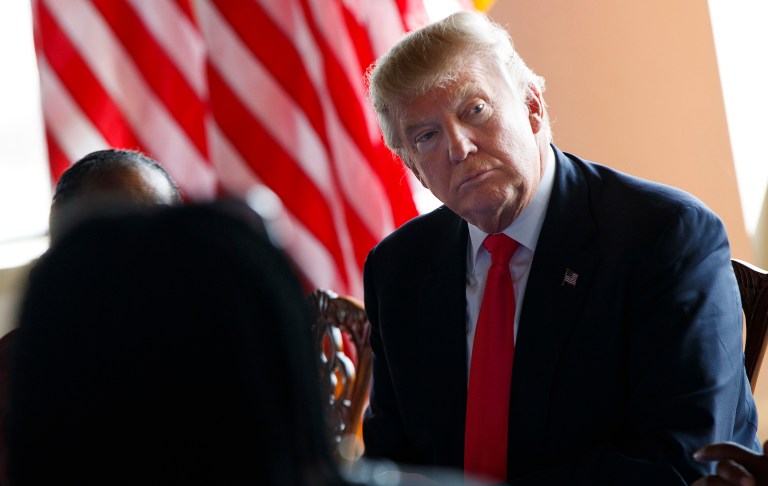 Ethics experts say President-elect Trump would have to divest himself of his business and put his wealth into a blind trust. (AP Photo/Evan Vucci)