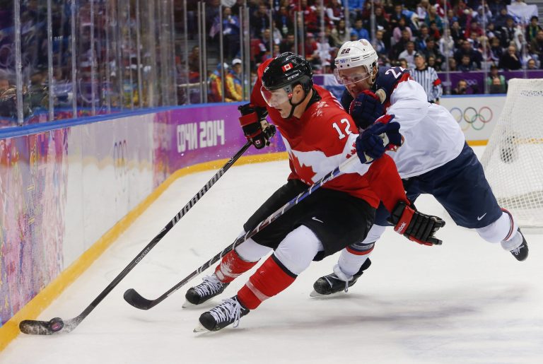 Canada forward Patrick Marleau seals the puck off from USA defenseman Kevin Shattenkirk during the third period of a men's semifinal ice hockey game at the 2014 Winter Olympics, Friday, Feb. 21, 2014, in Sochi, Russia. (AP Photo/Petr David Josek)