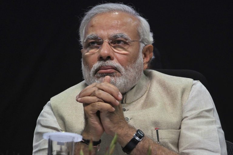 Gujarat state chief minister and opposition prime ministerial candidate Narendra Modi, who was denied a visa to enter the U.S. in 2005, sits during the 50th anniversary celebrations of the Bar Council of India in Gandhinagar, India, on Saturday. (AP Photo/Ajit Solanki)