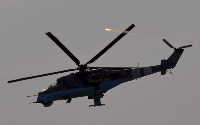 A Ukrainian helicopter gunship releases flares above areas where pro-Russian militias have taken positions around the airport outside Donetsk, Ukraine, on Monday, May 26, 2014. (AP Photo/Vadim Ghirda)