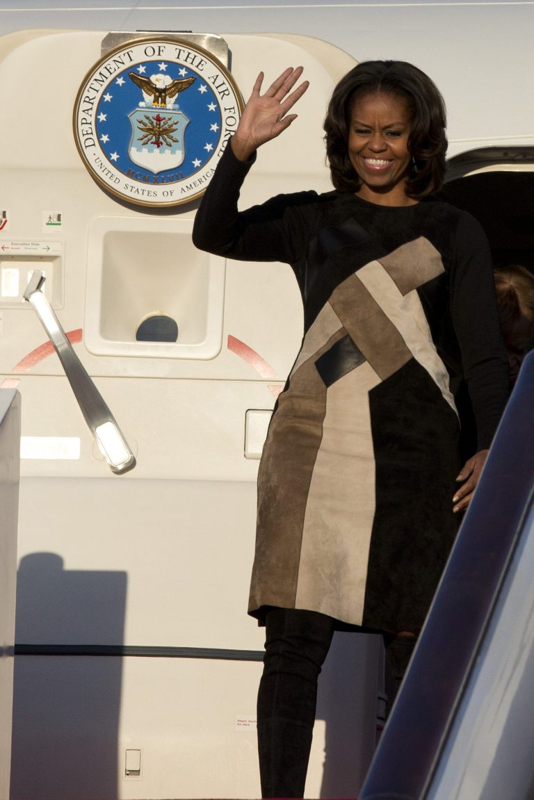 U.S. First Lady Michelle Obama waves as she arrives at Capital International Airport in Beijing, China, Thursday, March 20, 2014. Michelle Obama has arrived in Beijing with her mother and daughters to kick off a seven-day, three-city tour where she will focus on education and cultural exchange. (AP Photo/Alexander F. Yuan, Pool)