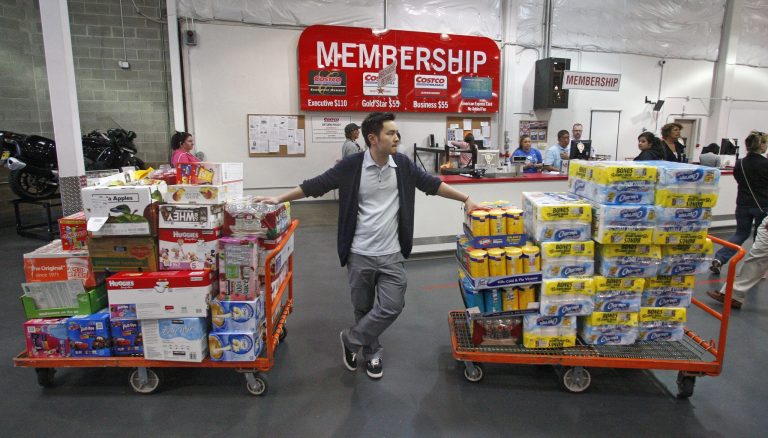   FILE-In this Wednesday, May 9, 2012, file photo, David Lee holds on to his carts while shopping at a Costco Wholesale in Portland, Ore. A steep drop in gasoline costs drove down a measure of U.S. wholesale prices in May by the most since July 2009. But outside the food and energy categories, prices increased moderately. (AP Photo/Rick Bowmer, File)  