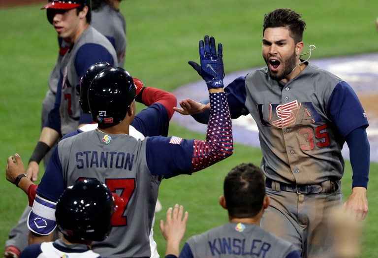 United States' Eric Hosmer (35) celebrates with teammates after scoring on a two-run double by Andrew McCutchen during the eighth inning of a second-round World Baseball Classic baseball game against the Dominican Republic on Saturday, March 18, 2017, in San Diego. (AP Photo/Gregory Bull)