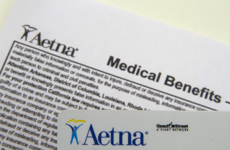 FILE - This Jan. 30, 2012 file photo, an Aetna benefits card is photographed  in Surfside, Fla. Aetna reports quarterly earnings on Thursday, April 24, 2014.  (AP Photo/Wilfredo Lee, File)