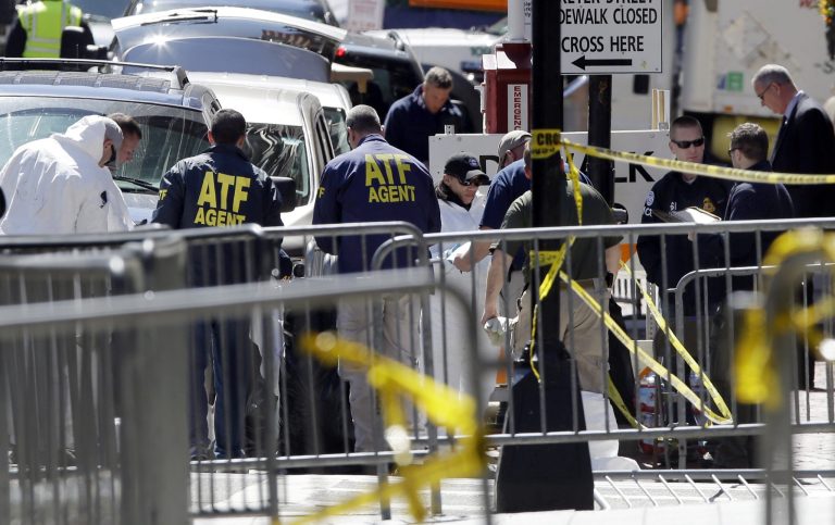ATF agents and others examine an area of Boylston Street in Boston Thursday, April 18, 2013, as investigation of the Boston Marathon bombings continues. (AP Photo/Elise Amendola)