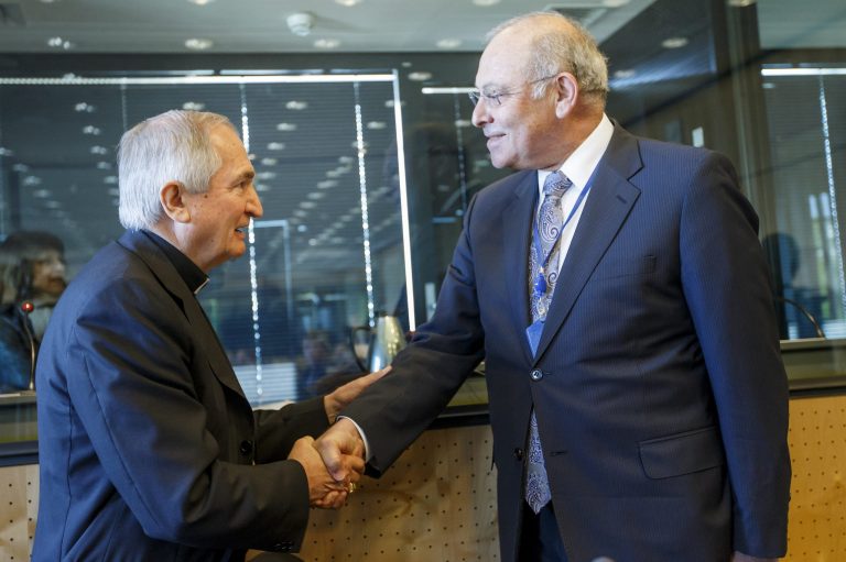 Archbishop Silvano M. Tomasi, left, Apostolic Nuncio, Permanent Observer of the Holy See (Vatican) to the Office of the United Nations in Geneva, shakes hand with Claudio Grossmann, right, Chairperson of UN Committee against Torture, prior the UN torture committee hearing on the Vatican, at the headquarters of the office of the High Commissioner for Human Rights (OHCHR) in the Palais Wilson, in Geneva, Switzerland, Monday, May 5, 2014. The UN Committee Against Torture hears the Holy See for the first time to consider whether the church's handling of child sexual abuse complaints has violated its obligations against subjecting minors to torture and to hear the Vatican on its efforts to stamp out child sex abuse by priests. (AP Photo/Keystone, Salvatore Di Nolfi)