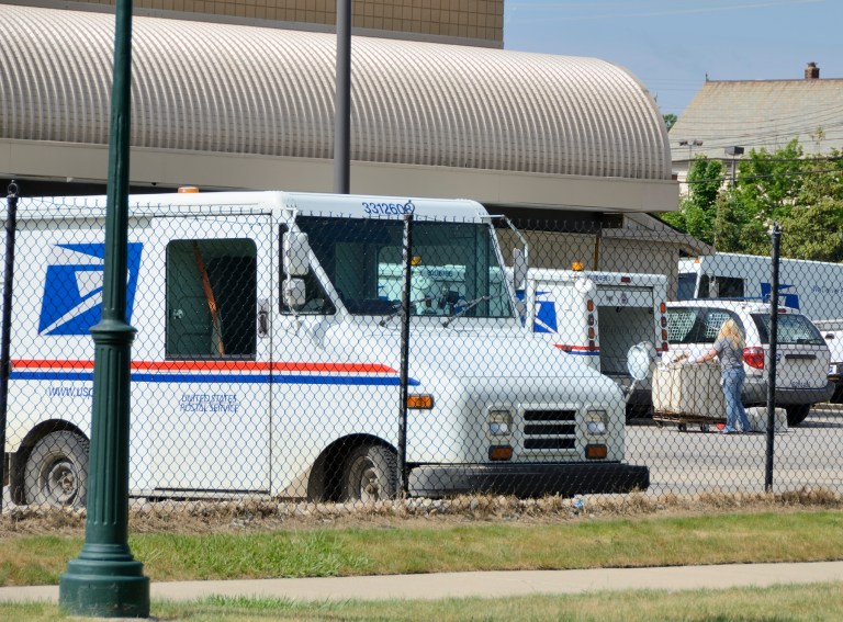 Postal worker loading mail at the United States Post Office in downtown Rochester, Michigan. (iStock Photo)