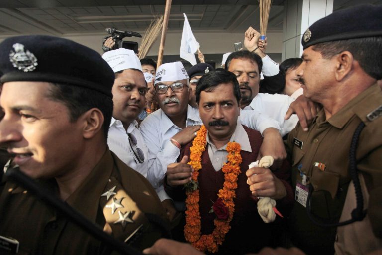 Anti-graft activist and leader of Aam Aadmi Party, or Common Man Party, Arvind Kejriwal is surrounded by supporters after his arrival at the airport as he begins his four-day visit of Gujarat state ahead of the countryâs national elections, in Ahmadabad, India, Wednesday, March 5, 2014. India said Wednesday it will begin national elections on April 7, kicking off a month-long contest in the largest democracy in the world. More than 810 million people are eligible to vote this year, an increase of 100 million from five years ago, according to the Election Commission. (AP Photo/Ajit Solanki)