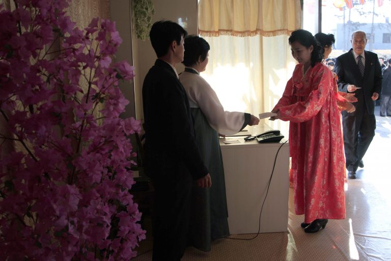 A woman receives a ballot to vote to elect deputies to the 13th Supreme People's Assembly  in Pyongyang, North Korea Sunday, March 9, 2014. North Korean voters went to polling stations to elect a new national legislature, although they don't get to choose who to vote for since there is only one candidate per district. (AP Photo/Kim Kwang Hyon)