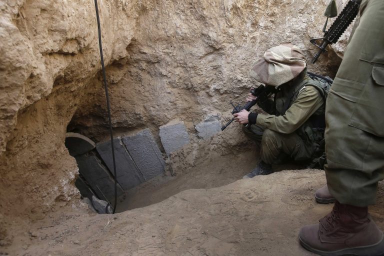 Israeli soldiers enter a tunnel discovered near the Israel Gaza border. (AP/Tsafrir Abayov)