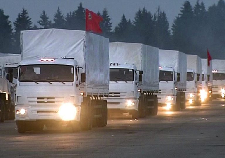 In this image taken from  video a convoy of white trucks with humanitarian aid leaves Alabino, outside Moscow Tuesday, Aug. 12, 2014. The convoy of 280 Russian trucks headed for eastern Ukraine early Tuesday, one day after agreement was reached on an international humanitarian relief mission. But the international Red Cross, which is due to coordinate the operation, said it had no information on what the trucks were carrying or where they were going. (AP Photo/ RTR via Associated Press Television) TV OUT RUSSIA OUT