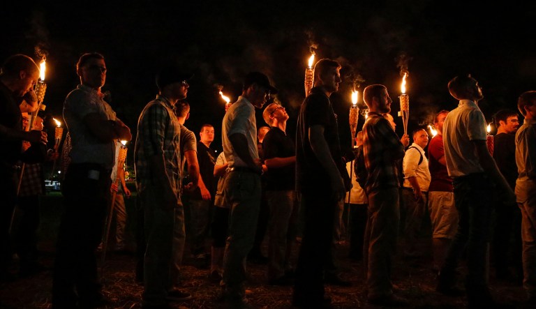 Multiple white nationalist groups march with torches through the UVA campus in Charlottesville, Va. Three of the country's uniformed military leaders condemned the deadly racist violence on display in Charlottesville, and said it is not welcome in the military. (Mykal McEldowney/The Indianapolis Star via AP)