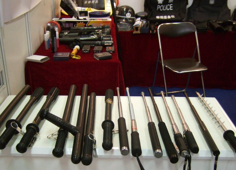 In this undated photo supplied by Amnesty International,  side handled and telescopic batons and spike batons are displayed at a police equipment exhibition, at an undisclosed location. Chinese production and export of police equipment primarily used for torture, such as electric shock wands and neck-and-wrist cuffs connected by a chain, has grown dramatically, enabling human rights violations at home and abroad, Amnesty International said in a report Tuesday, Sept. 23, 2014. (AP Photo/Amnesty International)