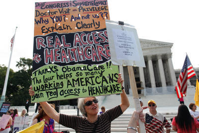 Protestors march outside the Supreme Court before a landmark ruling on healthcare in June. (Graeme Jennings/Examiner)
