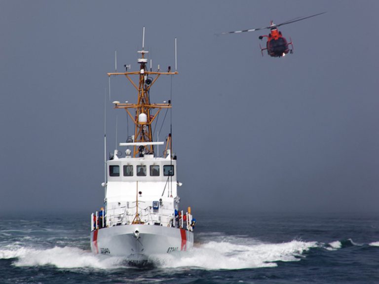   CORRECTS DATE OF CRASH TO SUNDAY, NOT MONDAY - In this Aug. 29, 2011 photo provided by the U.S. Coast Guard, a Rescue Helicopter from Airs Station Los Angeles conducts a close fly-by of the Coast Guard Cutter Halibut. A smuggler's vessel rammed a small U.S. Coast Guard boat deployed by the cutter Halibut, off the Southern California coast early Sunday Dec. 2, 2012, killing one Coast Guard member and injuring another, authorities said. The cutter was conducting an investigation into suspected smuggling near the Channel Islands west of Malibu. (AP Photo/U.S. Coast Guard/Steve Lee)  