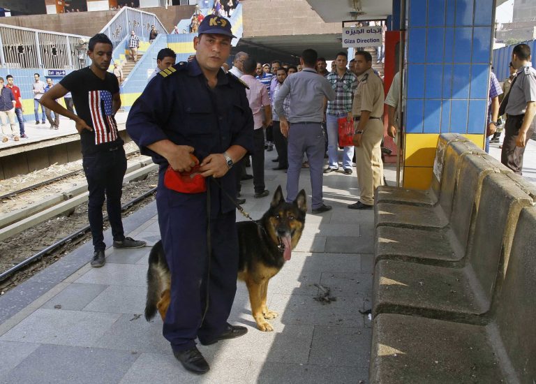 Egyptian security forces and civilians inspect damages after an explosion hit a subway station in Shubra el-Khemia northern Cairo, Egypt, Wednesday, June 25, 2014. Four minor explosions struck subway stations in Cairo on Wednesday, wounding two people and causing widespread panic among morning commuters, officials said. (AP Photo/Magdy Ebrahim, El Shorouk Newspaper) EGYPT OUT