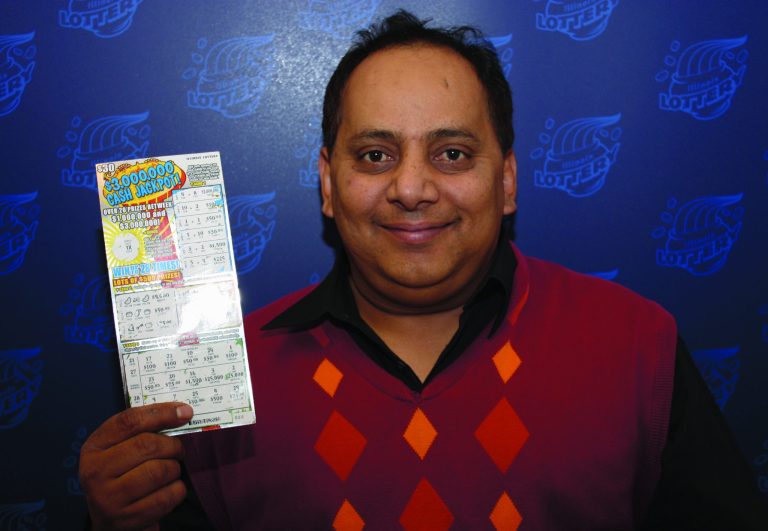This undated photo provided by the Illinois Lottery shows Urooj Khan, 46, of Chicago's West Rogers Park neighborhood, posing with a winning lottery ticket. The Cook County medical examiner said Monday, Jan. 7, 2013, that Khan was fatally poisoned with cyanide July 20, 2012, a day after he collected nearly $425,000 in lottery winnings. (AP Photo/Illinois Lottery)