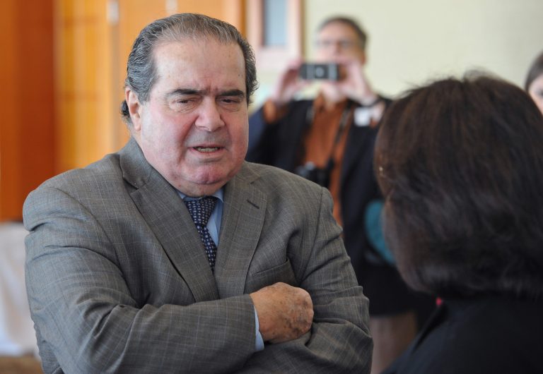 U.S. Supreme Court Justice Antonin Scalia greets participants at a constitutional law symposium where he delivered a talk called 
