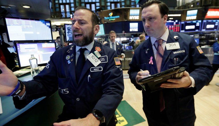 The Dow Jones industrial average dropped 1,175 points Monday but gained back almost half of that Tuesday afternoon. (AP Photo/Richard Drew)