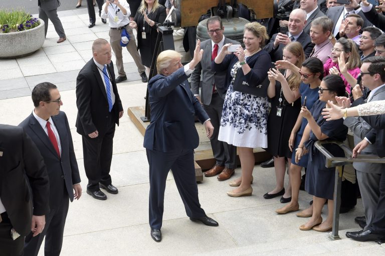 President Donald Trump and Treasury Secretary Steven Mnuchin, left, arrive at the Treasury Department in Washington, Friday, April 21, 2017, where the president was to sign an executive order to review tax regulations set last year by his predecessor, as well as two memos to potentially reconsider major elements of the 2010 Dodd-Frank financial reforms passed in the wake of the Great Recession. (AP Photo/Susan Walsh)