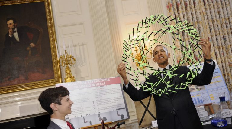 President Obama holds a model used to show how polymers expand as he talks with Peyton Robertson, 12, of Ft. Lauderdale, Fla., about how his sandless sandbags work while touring the 2014 White House Science Fair exhibits on display in the State Dining Room of the White House in Washington, Tuesday. Robertson designed a new kind of sandbag to protect against flooding from hurricanes and other disasters. Obama was celebrating the student winners of a broad range of science, technology, engineering and math (STEM) competitions from across the country. (AP Photo/Susan Walsh)